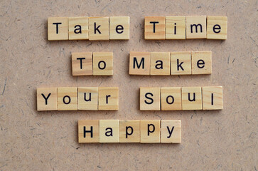 take time to make your soul happy text on wooden square, inspiration and motivation quotes
