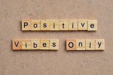 Positive Vibes Only text on wooden square, inspiration and motivation quotes