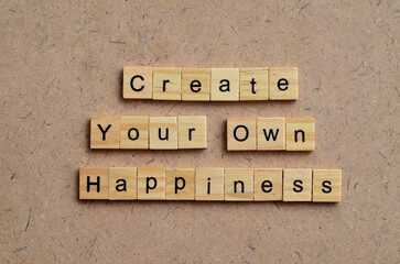 Create your own happiness text on wooden square, business motivation quotes
