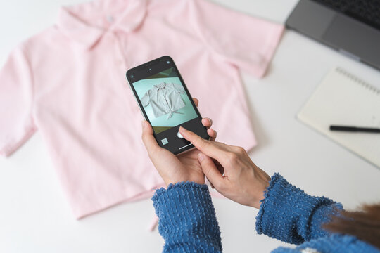 Small SME business, asian young woman, girl hand using mobile phone taking photo of clothing for sell clothes on smartphone, stream selling online, show product present detail, entrepreneur e commerce
