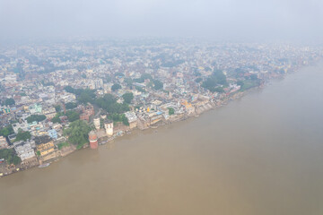 Fototapeta premium Aerial view of Varanasi city with Ganges river, ghats, the houses in Varanasi, Banaras, Uttar Pradesh, India