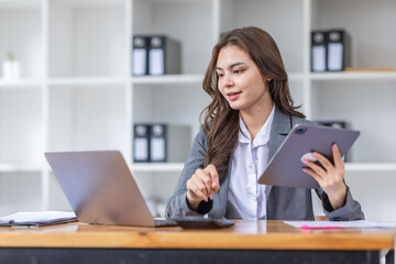 Young business Asian woman Accounting using calculating income-expenditure and analyzing real estate investment data report Financial and tax systems concept.	