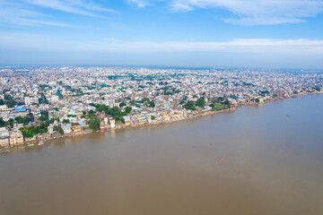 Naklejka na ściany i meble Aerial view of Varanasi city with Ganges river, ghats, the houses in Varanasi, Banaras, Uttar Pradesh, India
