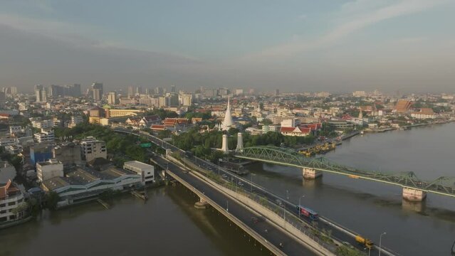 Aerial view of Phra Buddha Yodfa Bridge, Memorial Bridge and Phra Pok Klao Bridge over the Chaophraya River at sunrise scene, Bangkok City, Thailand.