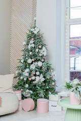 Close up view of Christmas tree branch with decorative balls, white flowers, toys and shining garland. Christmas tree branches with balls. winter holidays