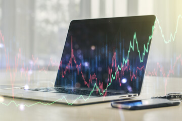 Multi exposure of abstract financial graph on laptop background, financial and trading concept