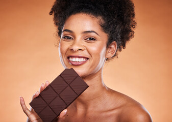 Chocolate, happy woman and beauty portrait on studio background eating sweets, dessert or sugar....
