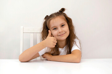 portrait of charming smiling girl with long hair gives thumbs up like beautiful advertisement highlighted on white background. Discount symbol of selected season