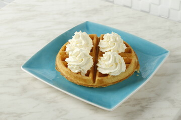 Waffles with whipped butter and maple syrup