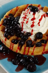 Waffle with blueberries, blueberry syrup and whipped butter