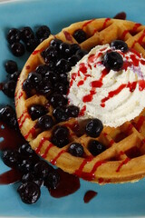 Waffle with blueberries, blueberry syrup and whipped butter