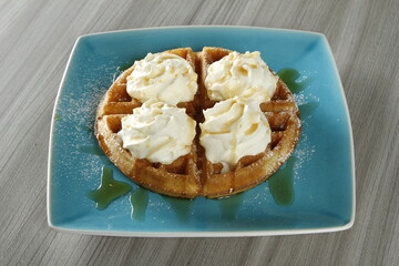Waffles with whipped butter and maple syrup