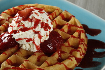 Waffles with strawberries, strawberry syrup and whipped butter
