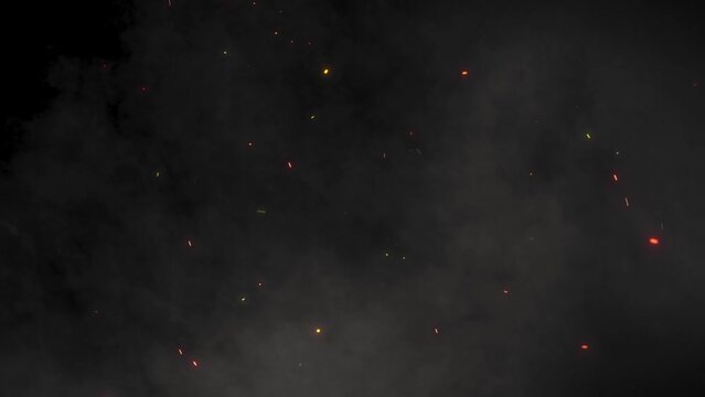 Fire sparks rising up with transparent alpha channel can be used for overlay for your project. 4K 3D animation of fiery orange glowing flying ember burning ash particles.