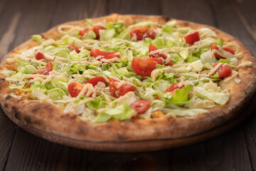 Delicious Pizza Caesar with Parmesan cheese on wooden table