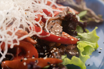 Delicious Thai Beef Salad presented in a blue plate