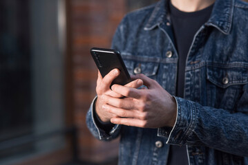 Close-up of male hands using a mobile phone or smartphone.
