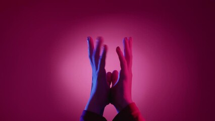 Wait answer. Hand expression. Visual gesture. Female palms holding together shaking fingers feeling impatience on neon light pink blue background.