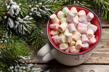 Cup with marshmallow and fir tree with snow