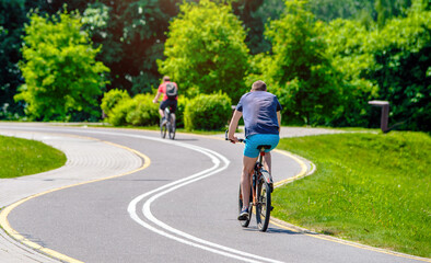 Fototapeta premium Cyclist ride on the bike path in the city Park 