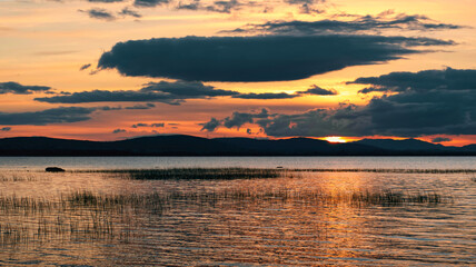 Dramatic cloudy sunset scenery of Corrib lake and mountains in the background at Galway, Ireland 