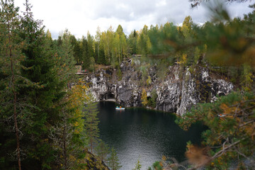 Fototapeta na wymiar boats floating on the lake in the marble canyon surrounded by autumn forest