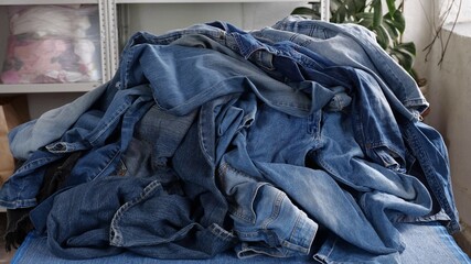 Old denim jeans, textile waste, Denim fabric. Recycling denim clothing. Cotton-based clothing, such as denim, makes up a large proportion of textile waste
