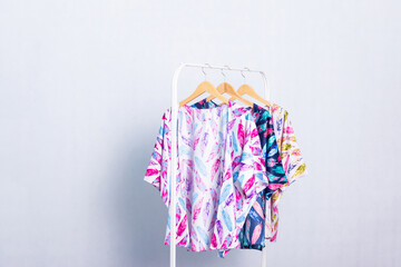 Colourful womens wardobe for daily wear or formal outfit. Outwear on the hanger on the white background. You can add some text or another object