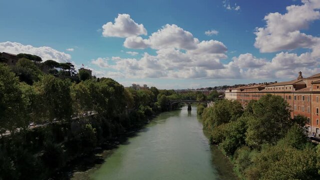 Sublicio bridge over Tiber river with city in background, Rome in Italy. Aerial forward ascending