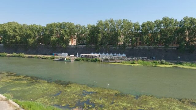 View of promenade and Tiber river, legend of Romulus and Remus on the river Tiber in Rome