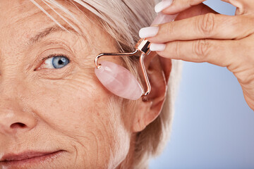 Mature woman, face and facial roller for smooth, anti aging and lifting treatment for wrinkles and...