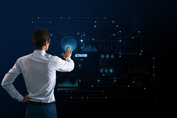 Virtual reality concept with man back view pushing button on digital touch screen with technological interface