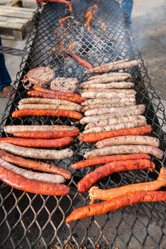 Grillade de sauccisses et chipolatas sur un barbecue artisanal