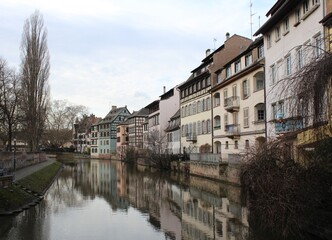Fototapeta na wymiar Old houses, leaning out, on a canal of the river Rhine in Strasbourg