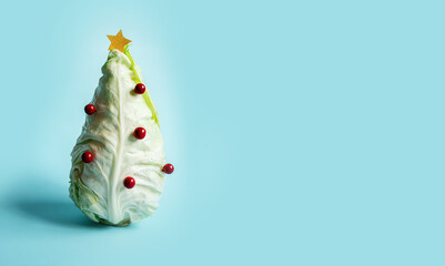 stylish creative new year layout with a cabbage
 in the shape of a Christmas tree with decorations...