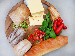 
Ingredients for making a basic butter board. Butter with jalapeno, spring onion, chives and other herbs, served with selection of breads
