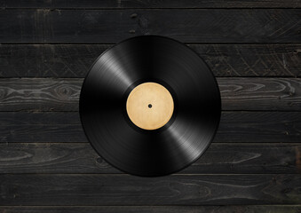 Vinyl record isolated on black wood background