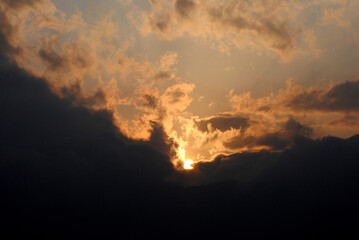 A magnificient view of sun hiding in the dark clouds during sunset looks mesmerizing as seen from Gangtok in Sikkim. Sunrise (dawn) and sunset (dusk) gives excellent view to capture in your camera.