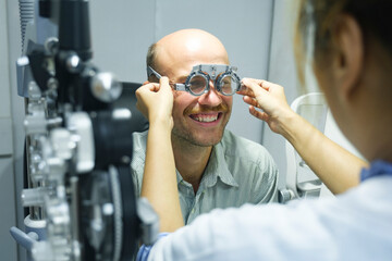 Man examining eyesight in optical clinic.