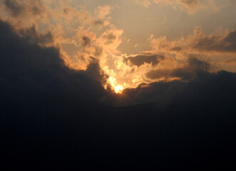 A magnificient view of sun hiding in the dark clouds during sunset looks mesmerizing as seen from Gangtok in Sikkim. Sunrise (dawn) and sunset (dusk) gives excellent view to capture in your camera.