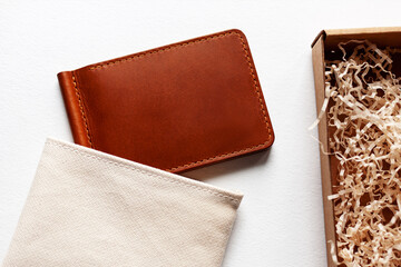 Leather wallet from a gift box on a white background.