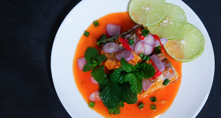 Canned fish salad on a dark background. Select focus.