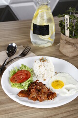 Pork tocino, a Filipino and Spanish breakfast meat, with egg, tomatoes, lettuce and garlic fried rice