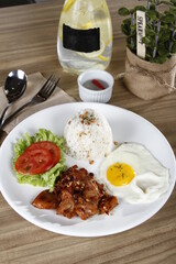Pork tocino, a Filipino and Spanish breakfast meat, with egg, tomatoes, lettuce and garlic fried rice