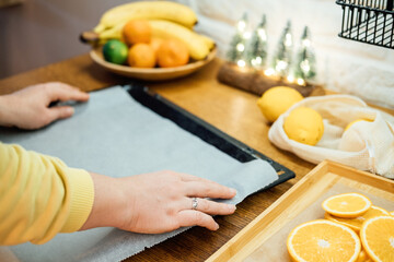 How to Dry Orange Slices for Eco friendly zero waste Holiday Decor. Close up Process of Drying Orange Slices in Oven. Woman cutting slices of orange and citrus fruits for drying in oven in kitchen