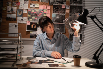 Detective working in her office with evidence