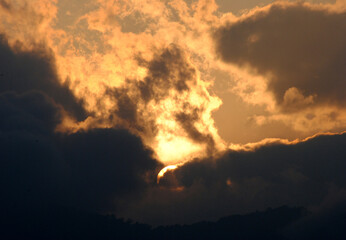 A magnificient view of sun hiding in the dark clouds during sunset looks mesmerizing as seen from Gangtok in Sikkim. Sunrise (dawn) and sunset (dusk) gives excellent view to capture in your camera.