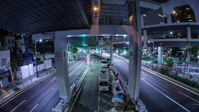A night timelapse of the traffic jam at the urban street in Tokyo fish eye shot tilt