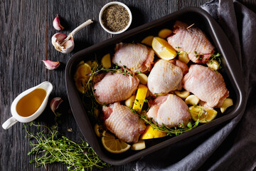 raw chicken thighs with lemon, thyme and spices
