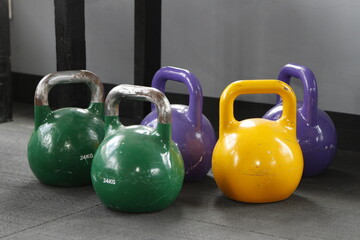 Fototapeta na wymiar Kettlebells of different colors and weights